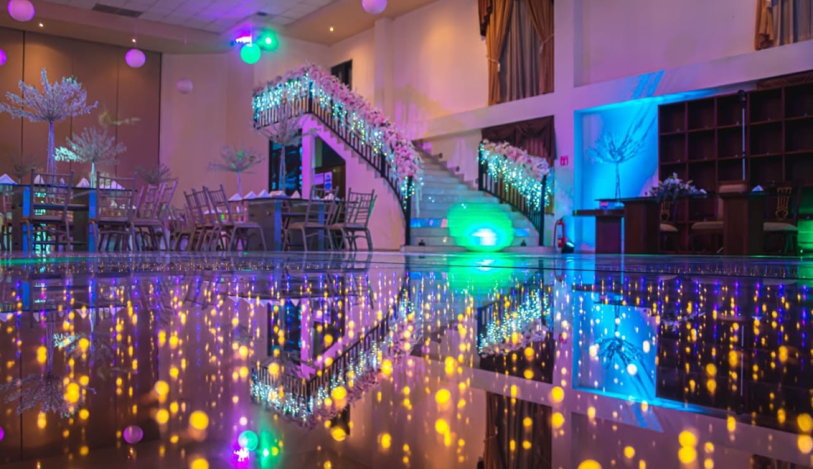 Pista iluminada y escalera con flores en el salón VillaMont
